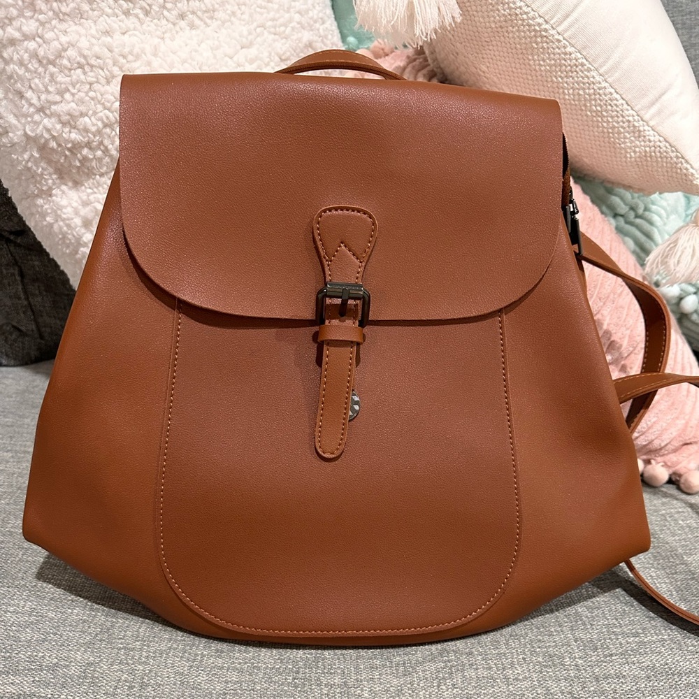 Leather backpack tags still on